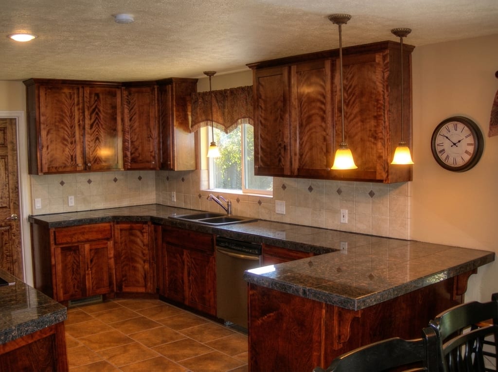 Mattos solid-wood kitchen remodel: Solid cherry wood cabinetry installed with granite tile counters