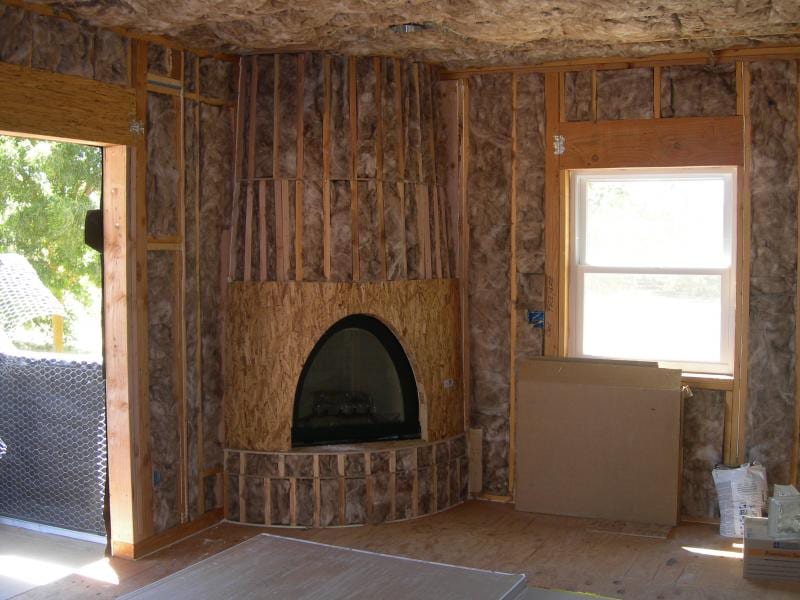 Chowchilla custom home framing and stucco: Exterior timber framing and roof structure enclosed across the main wing
