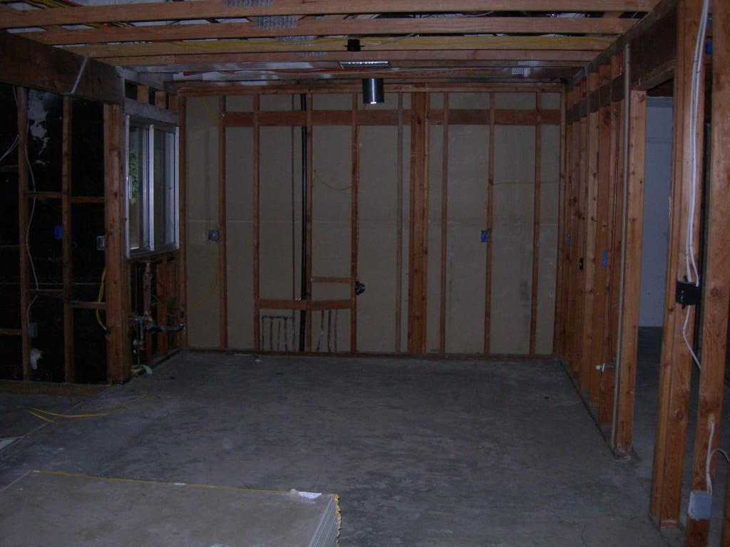 Structural fire damage rebuild: New structural wall studs and roof rafter framing underway