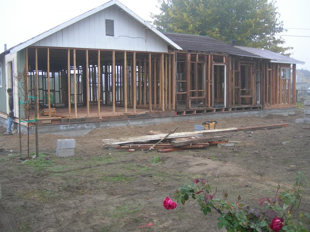 Garcia whole-house strip, foundation lift, and remodel: New exterior wall stud framing and window rough openings over the new foundation