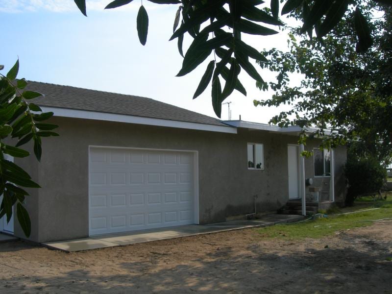 Magneson foundation lift and exterior remodel: Front elevation framing for covered porch addition and new garage