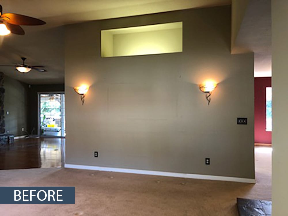 Whole-home structural remodel: Original living room fireplace and partition wall before removal