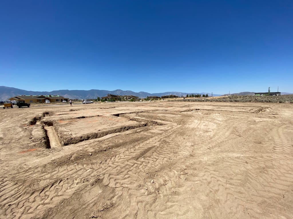Custom built house in Minden: Excavated foundation trenches across the home pad with Sierra Nevada views